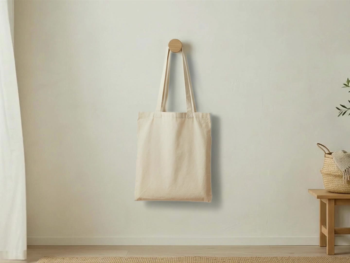 Animated tote bag mockup scene: a natural cotton tote bag hanging from a wooden wall peg next to a sheer curtain