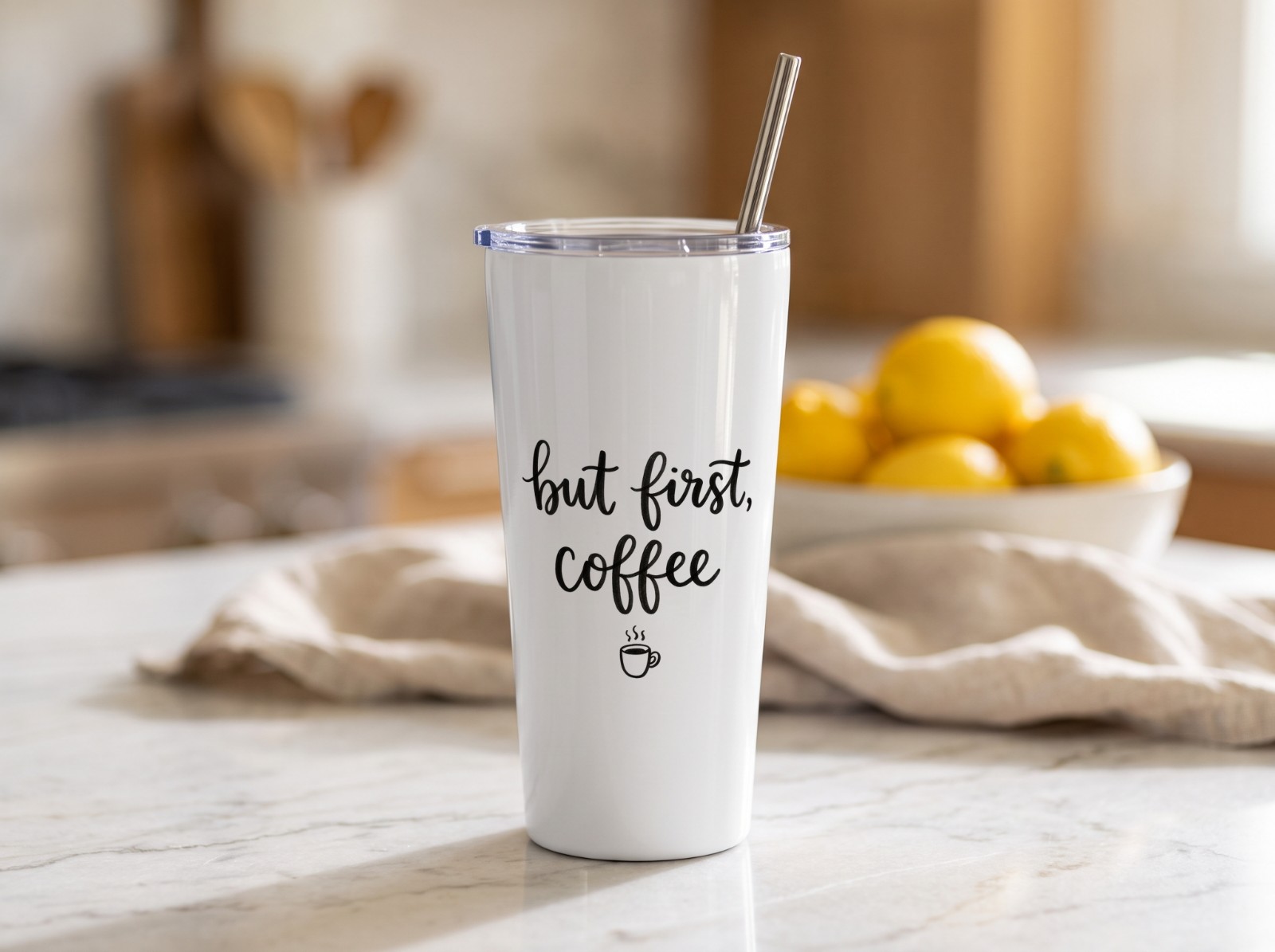 20 oz Tapered Tumbler on a Marble Kitchen Counter with Lemons showing a But First Coffee lettering design
