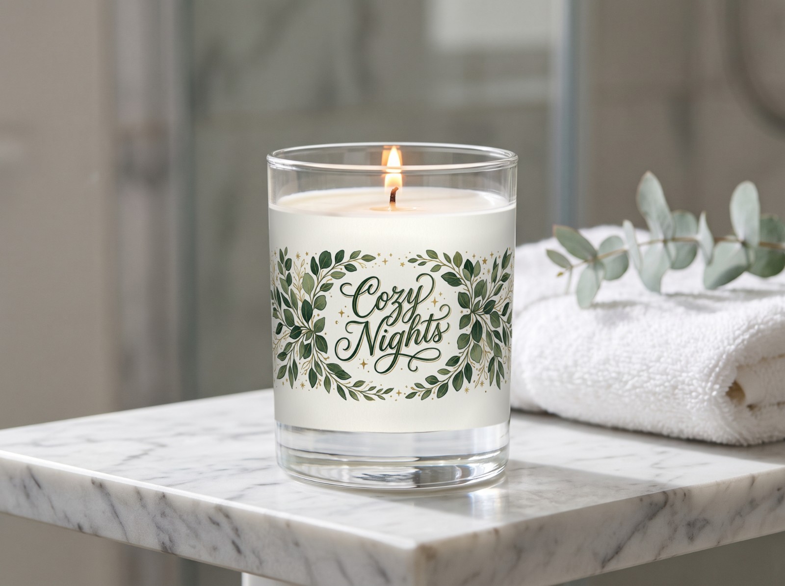 Clear Glass Candle on a Marble Bathroom Shelf showing a Cozy Nights eucalyptus label