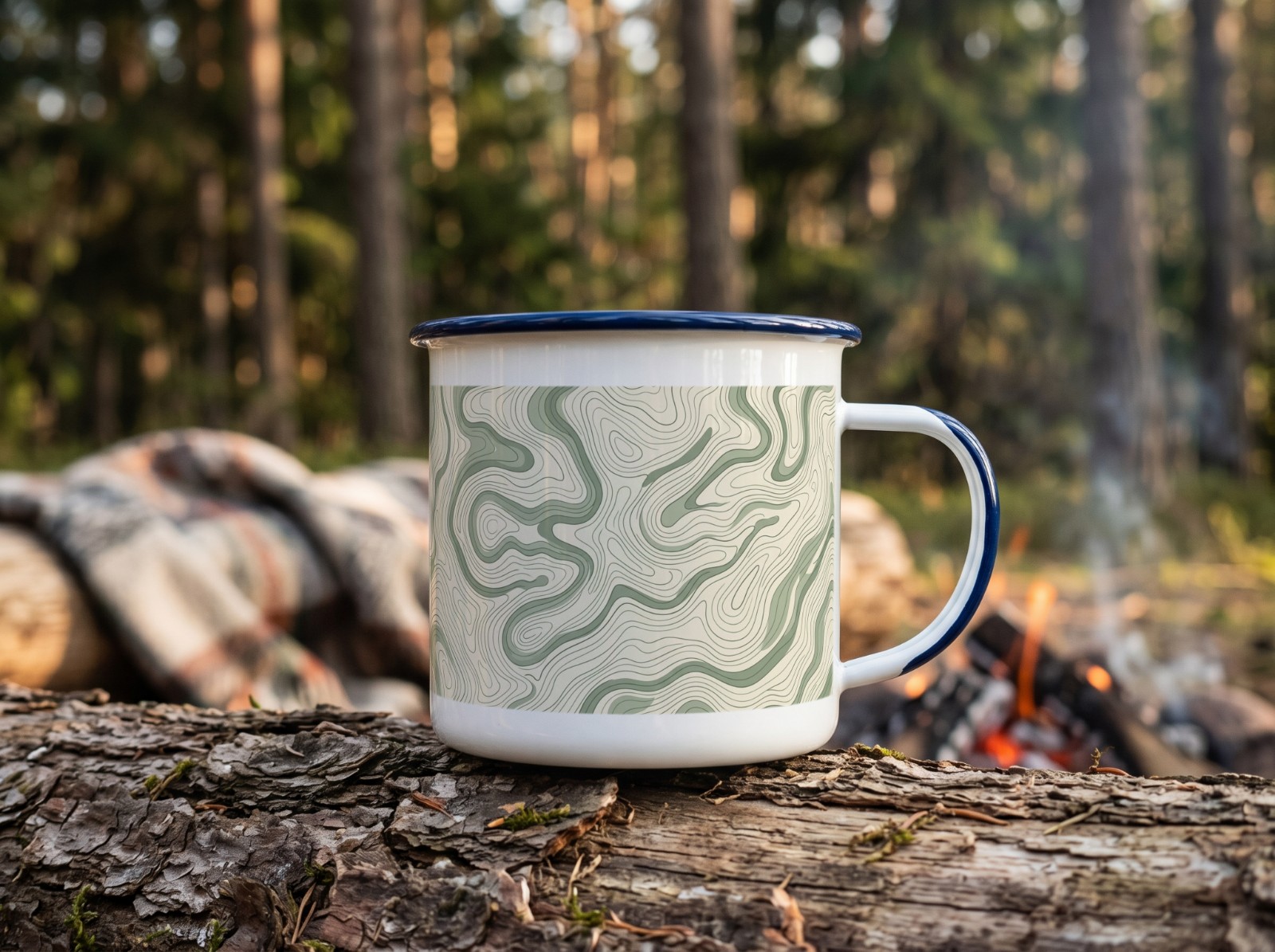 Enamel Camp Mug on a Log by the Campfire showing a sage topographic map pattern