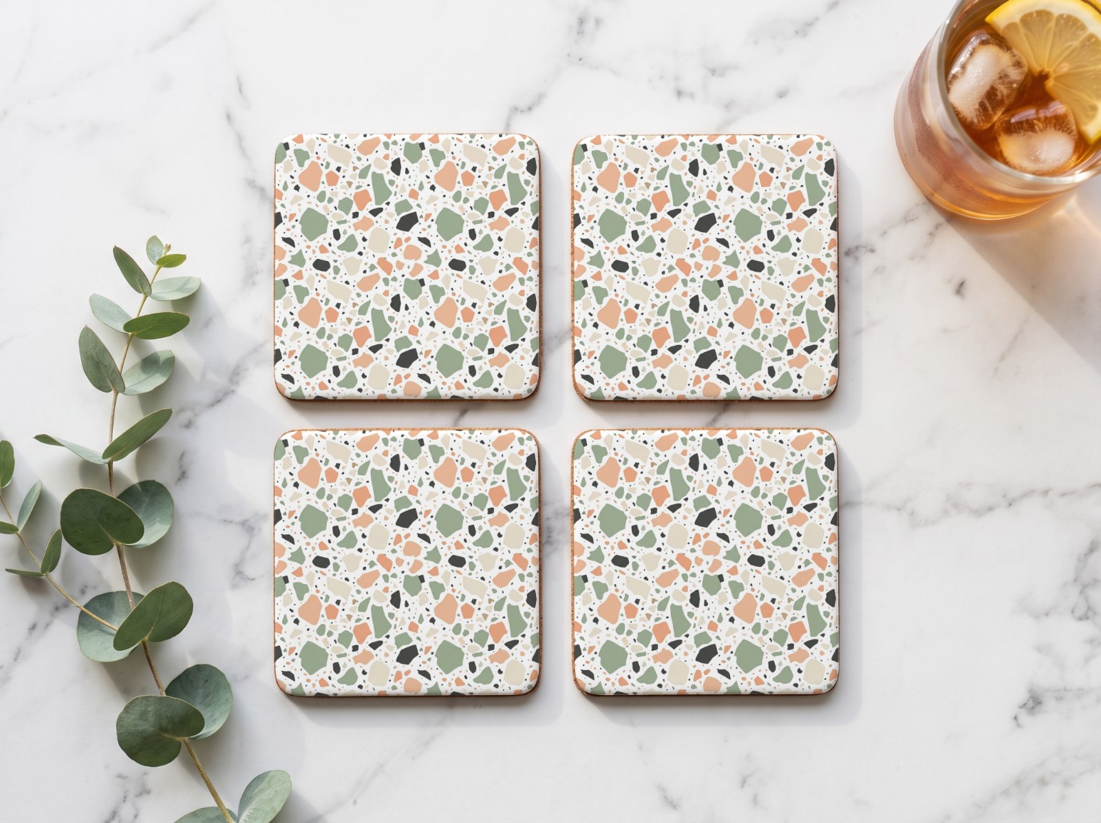 Set of Four Square White Coasters on a Marble Table showing a pastel terrazzo pattern