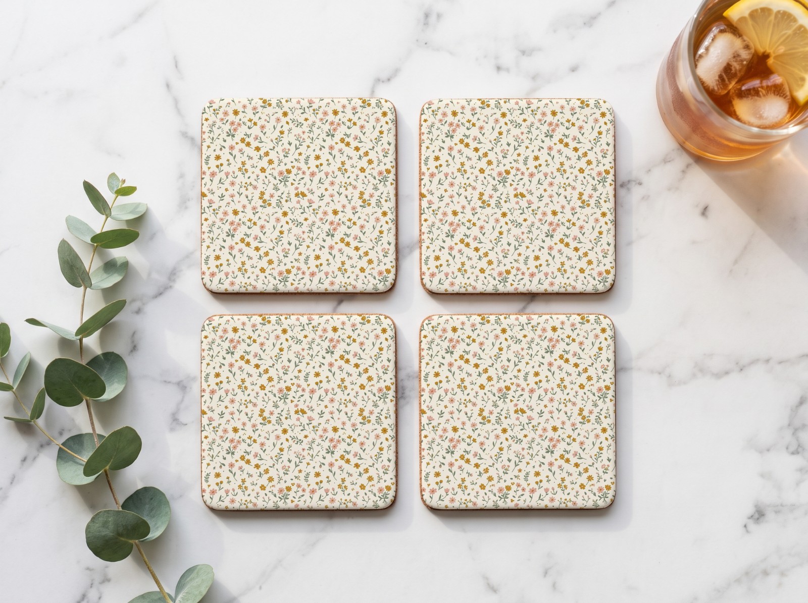 Set of Four Square White Coasters on a Marble Table showing a ditsy wildflower pattern