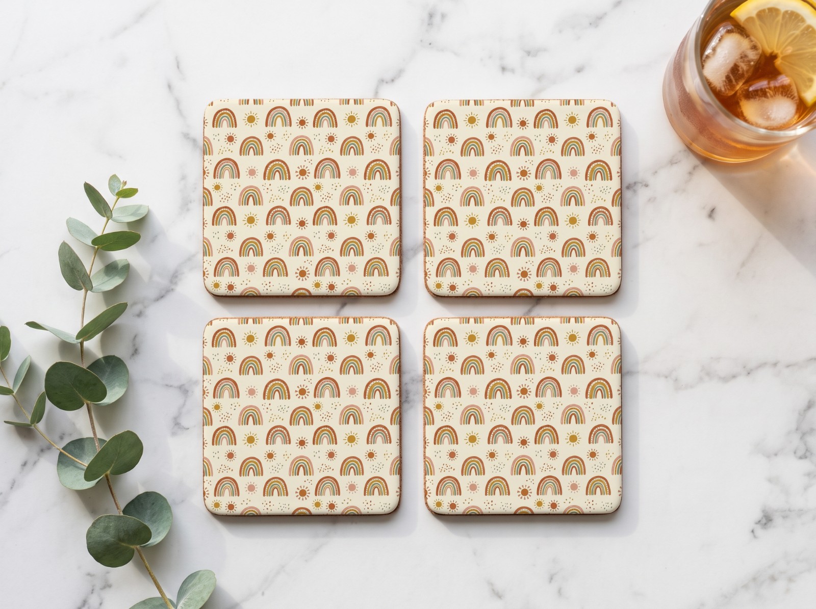 Set of Four Square White Coasters on a Marble Table showing a boho rainbow pattern