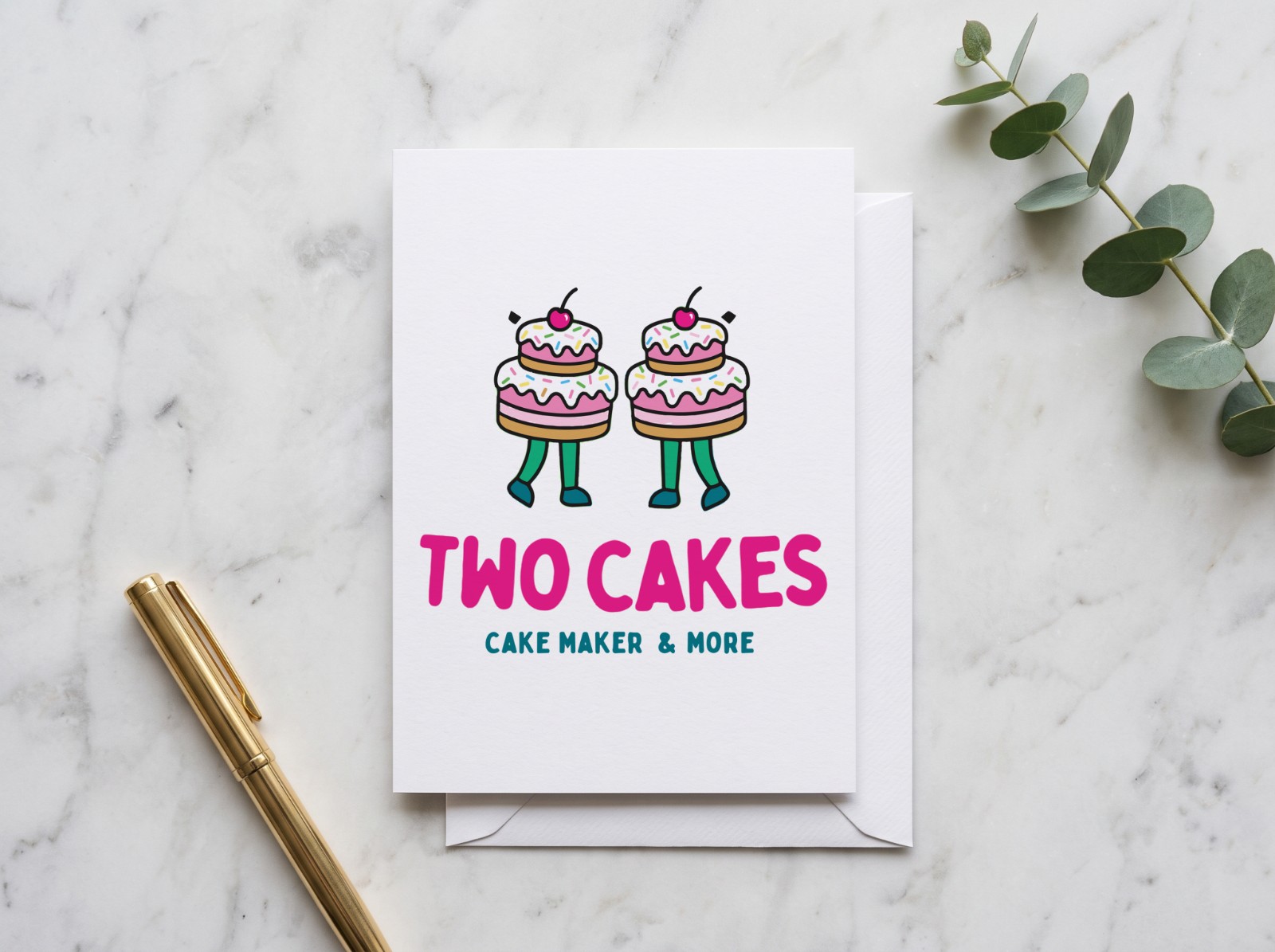 Greeting Card on White Marble with Eucalyptus showing the Two Cakes logo