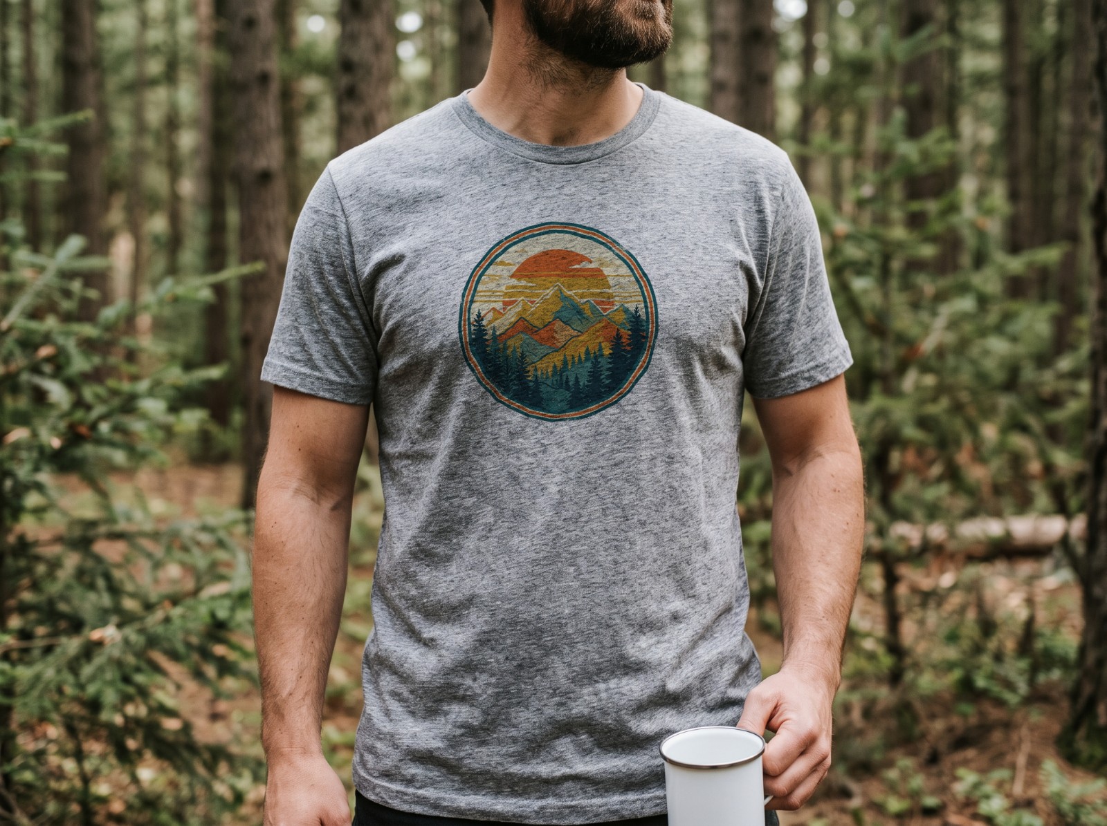 Heather Grey T-Shirt on a Man in a Pine Forest showing a retro mountain sunset badge