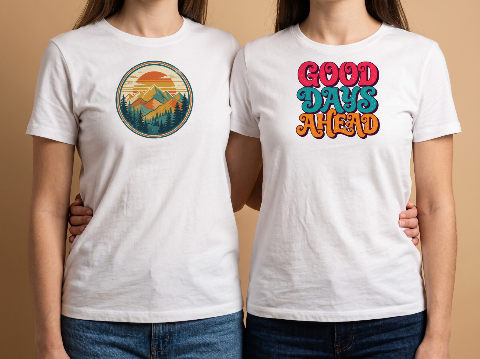 Matching White T-Shirts on Two Friends in a Studio showing a retro mountain badge and a Good Days Ahead lettering