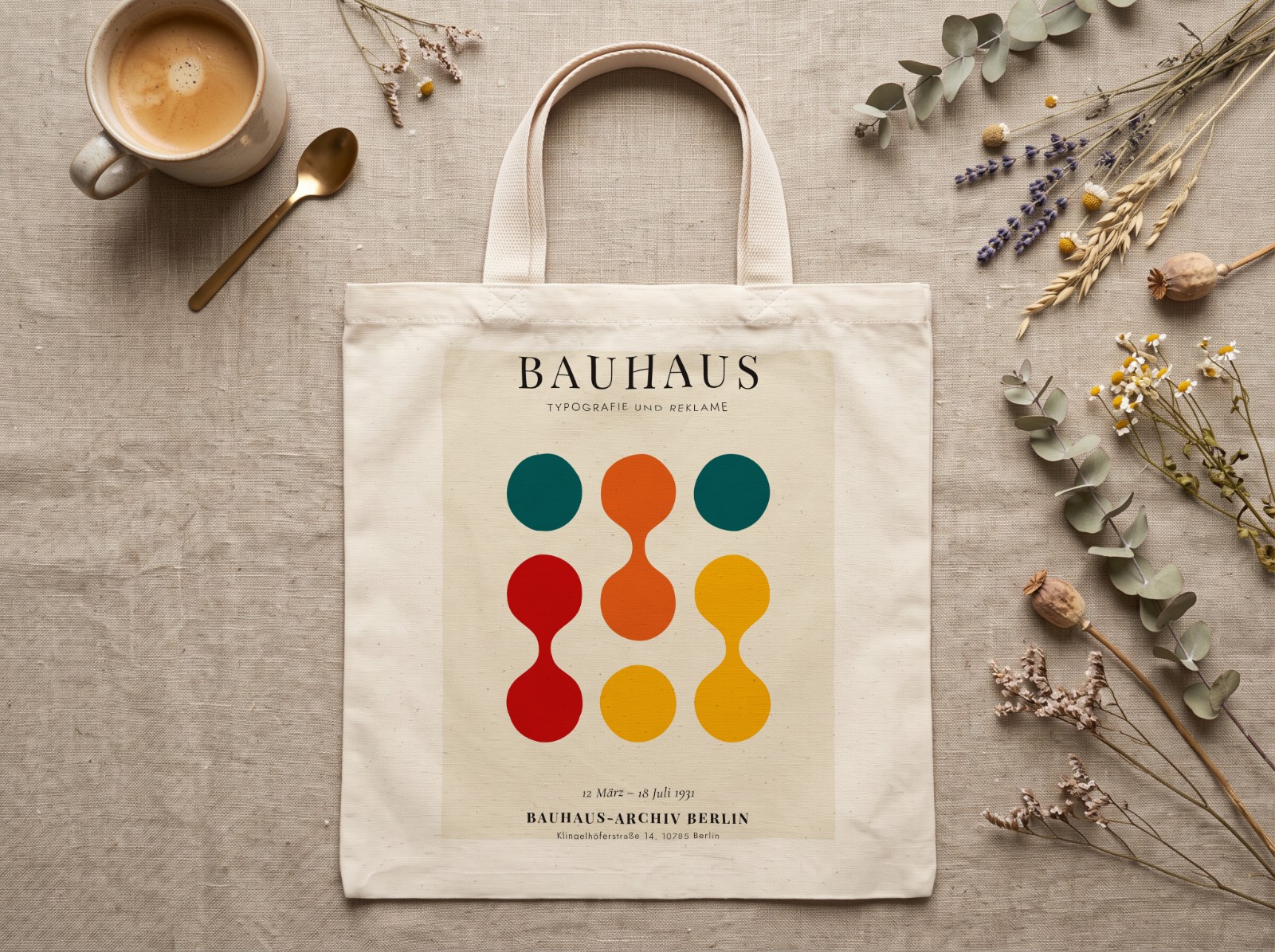 Natural Tote Bag Flat Lay on Linen with Dried Flowers showing a Bauhaus Typografie print