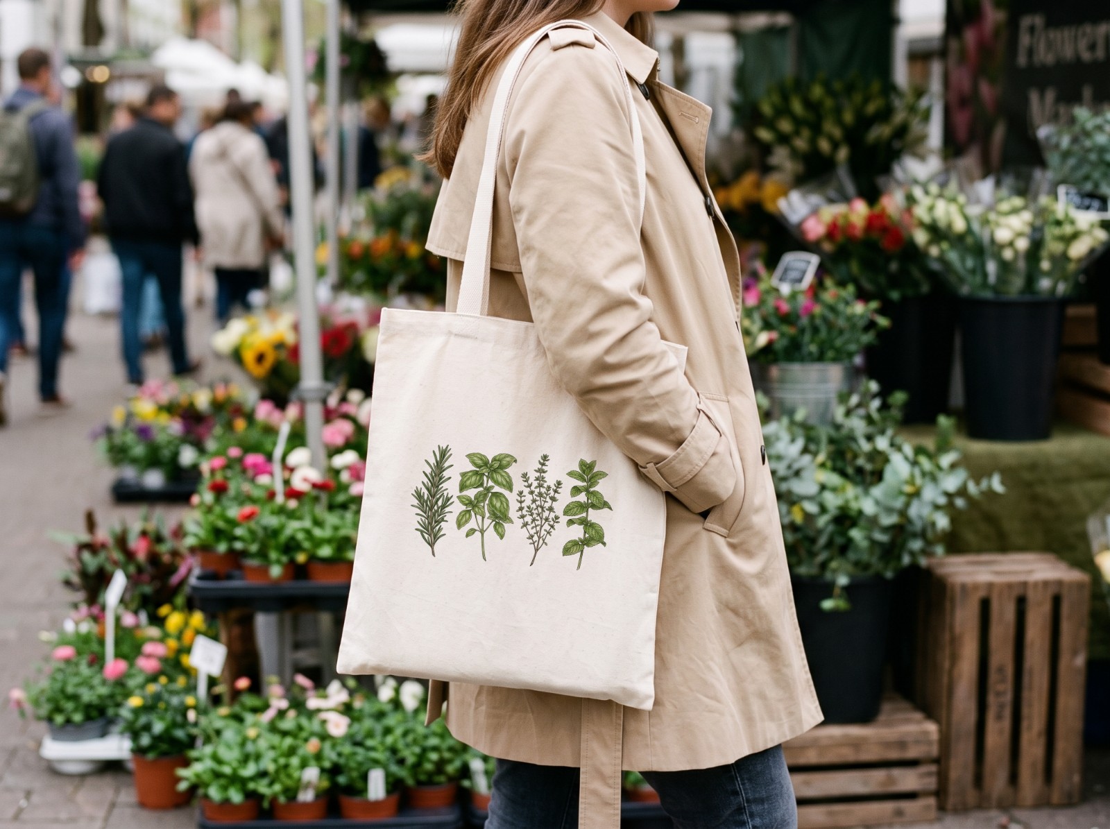 Natural Tote Bag on a Woman's Shoulder at a Flower Market showing a kitchen herbs illustration