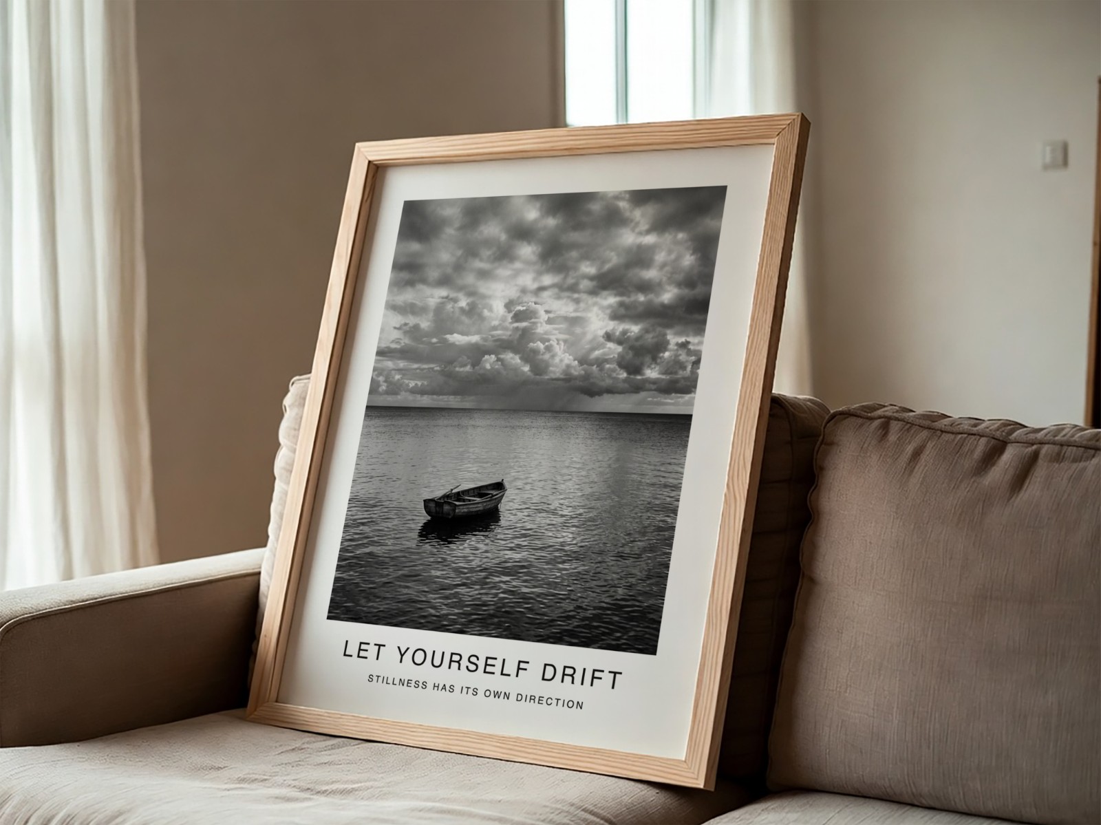 Oak Frame Leaning on Grey Sofa showing a black and white seascape print