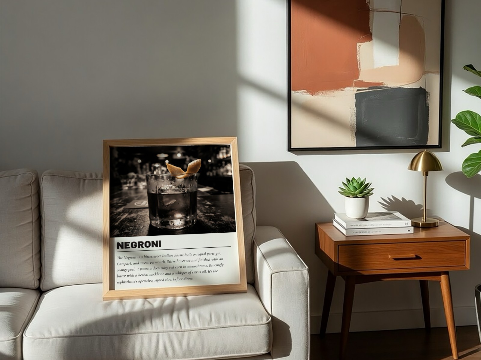 Oak Frame on Sofa with Abstract Art showing a Negroni cocktail print