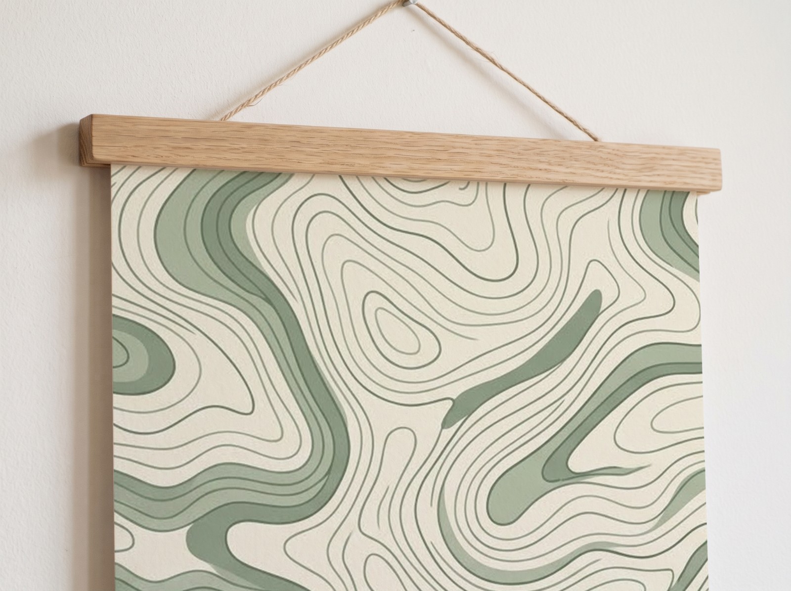 Close-up of a poster with a sage topographic line print in an oak hanger