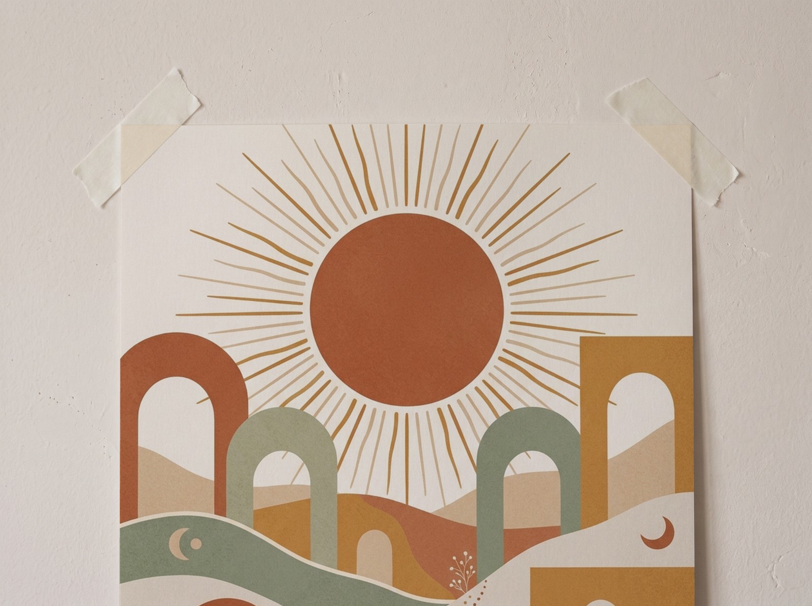 Close-up of a taped poster with a boho sun and arches print on a plaster wall