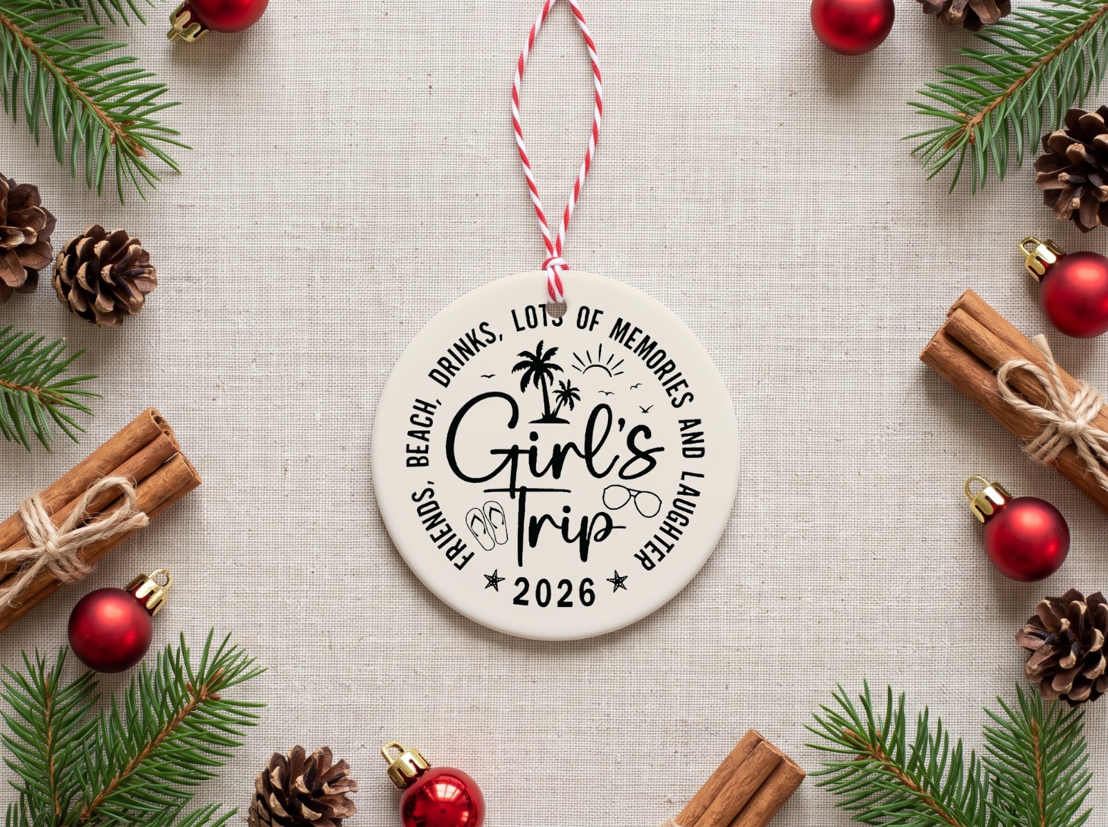 Round Ceramic Christmas Ornament Flat Lay with Pine showing the Girl's Trip 2026 design