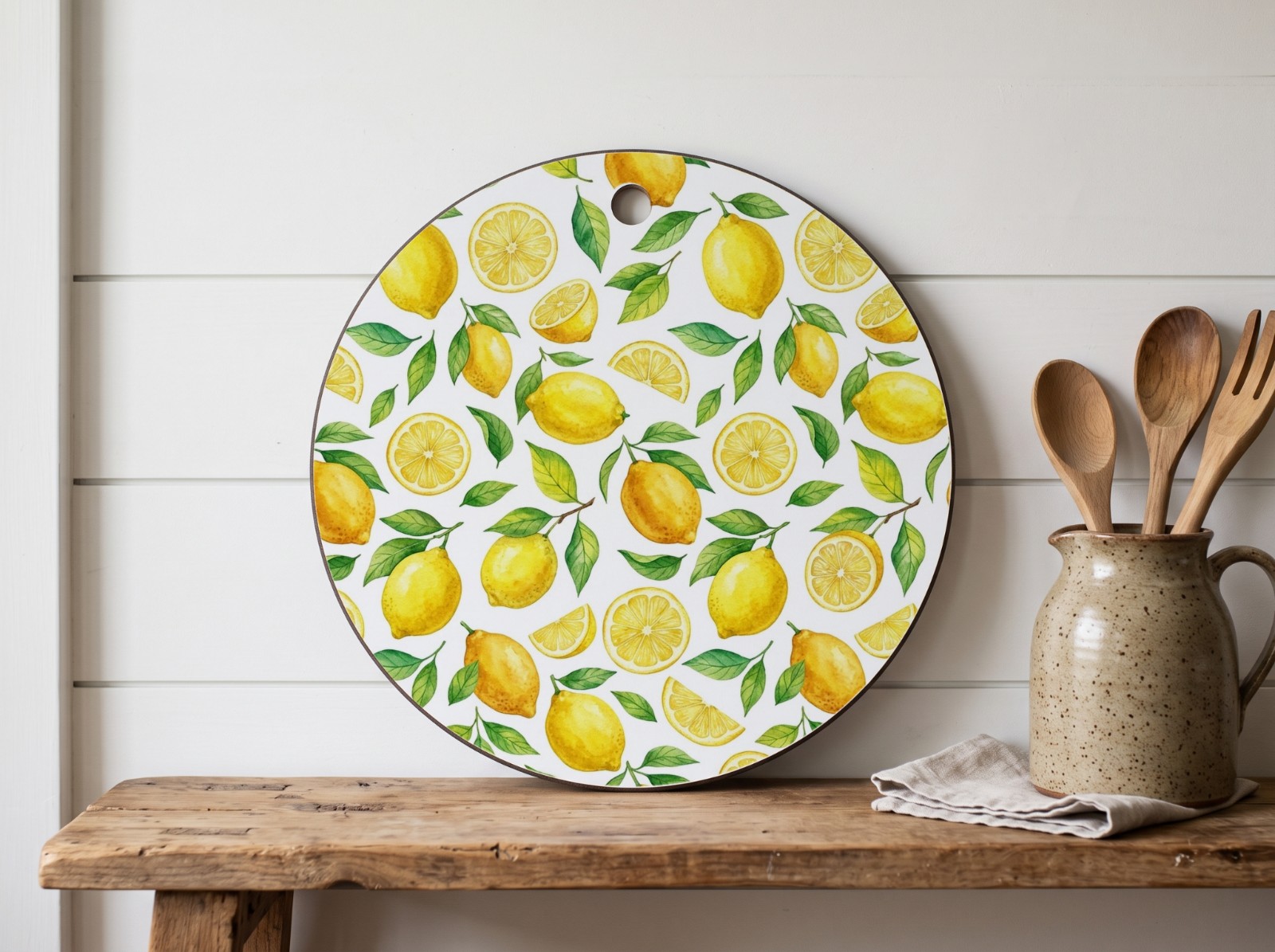 Round White Cutting Board on a Farmhouse Shelf showing a watercolour lemon pattern