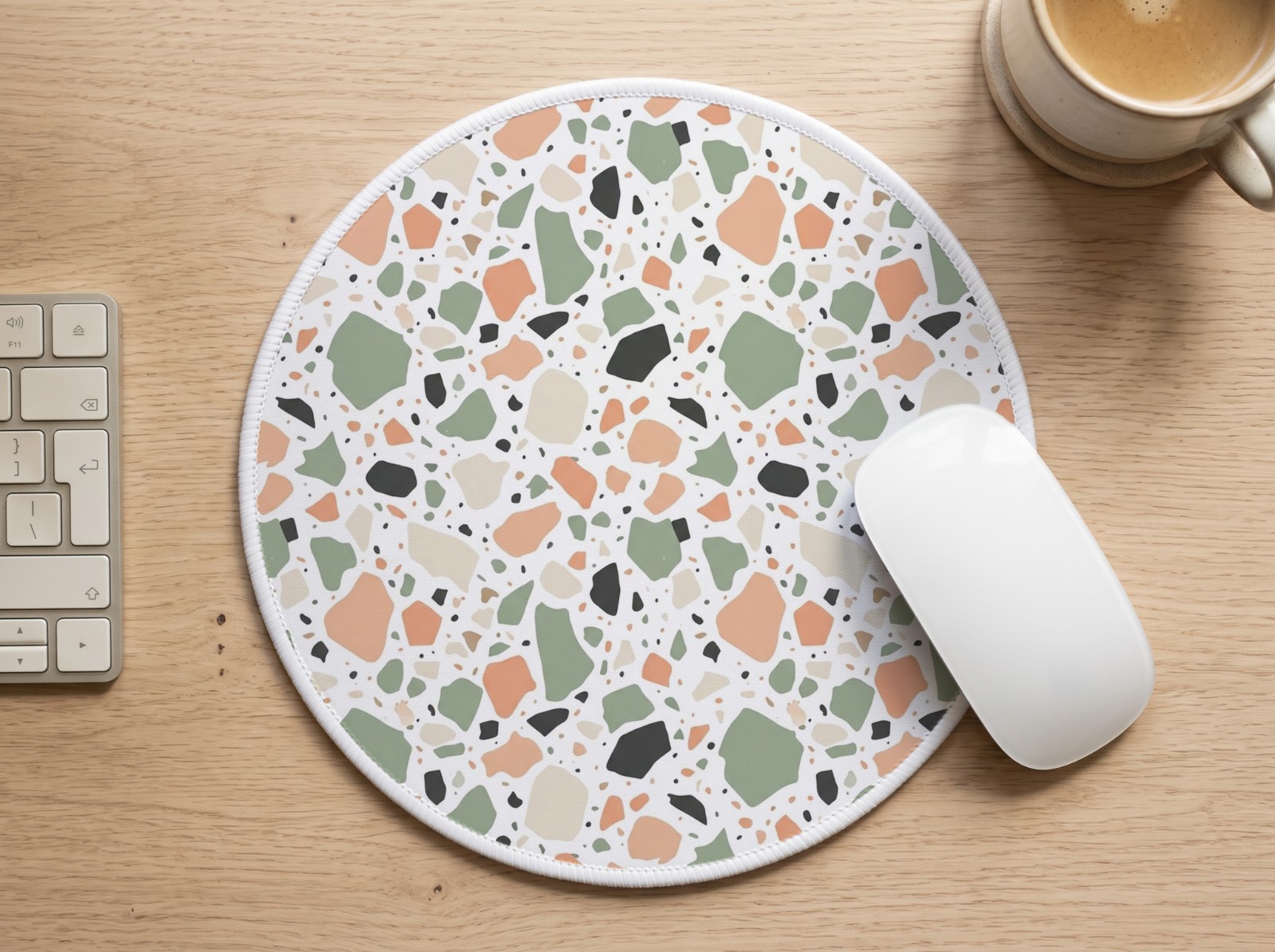 Round White Mouse Pad on an Oak Desk showing a pastel terrazzo pattern