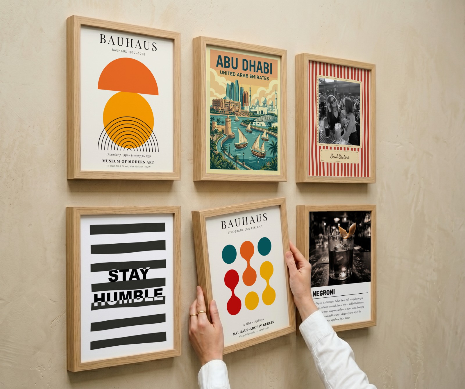 Six Oak Frame Gallery Wall, Angle View showing a Negroni cocktail print, a Bauhaus circles print and 4 more designs