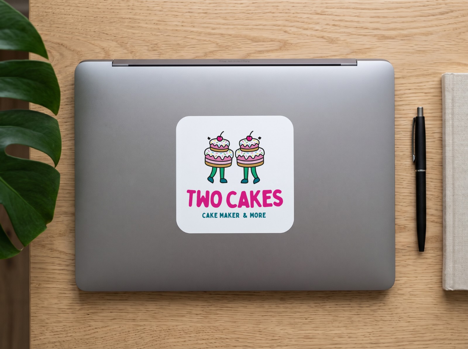 Square Vinyl Sticker on a Laptop Lid showing the Two Cakes logo