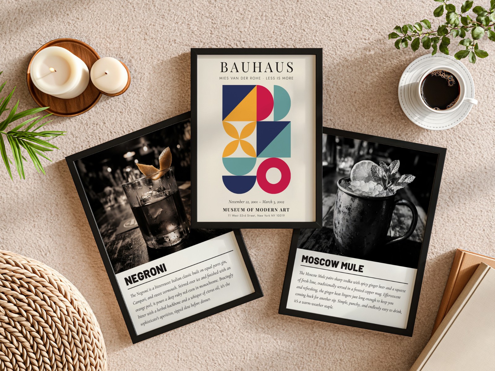 Three Black Frames Flat Lay on Beige Carpet showing a Bauhaus geometric print, a Moscow Mule cocktail print and 1 more design