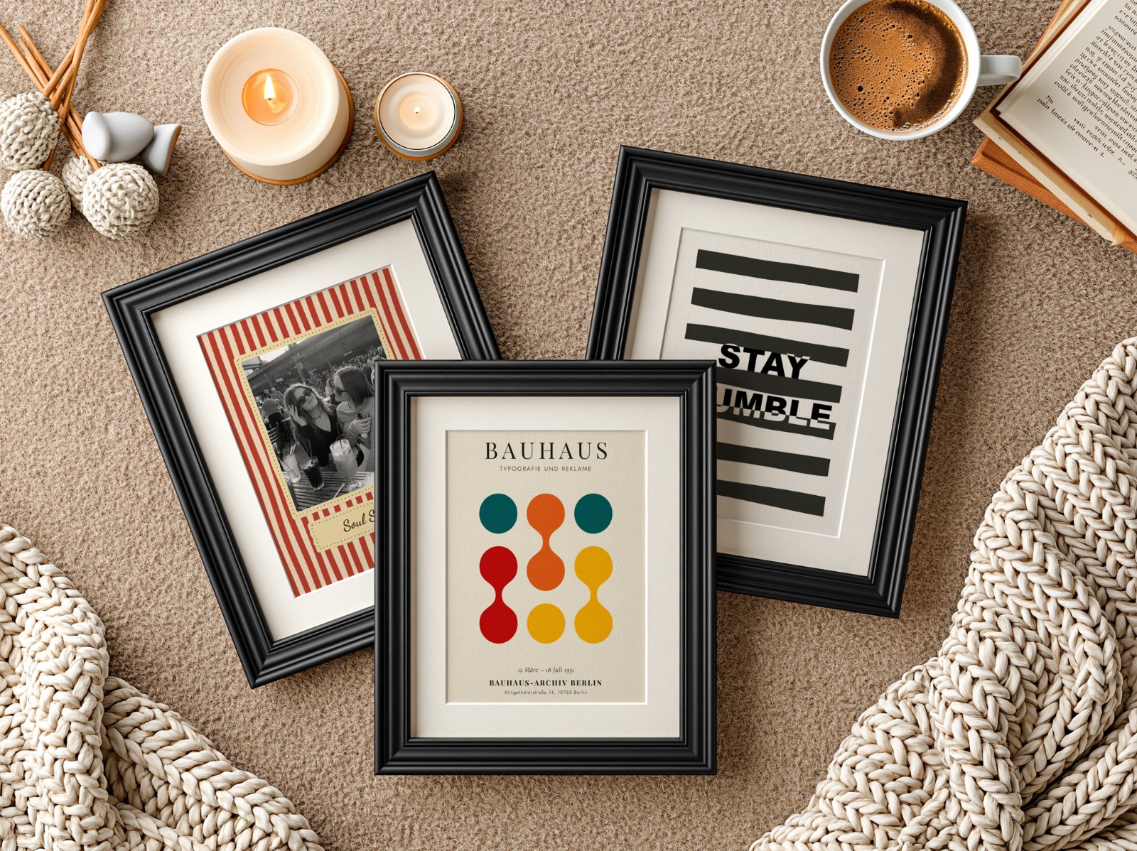 Three Black Frames with Mats on Knit Blanket showing a Bauhaus circles print, a Stay Humble typography print and 1 more design