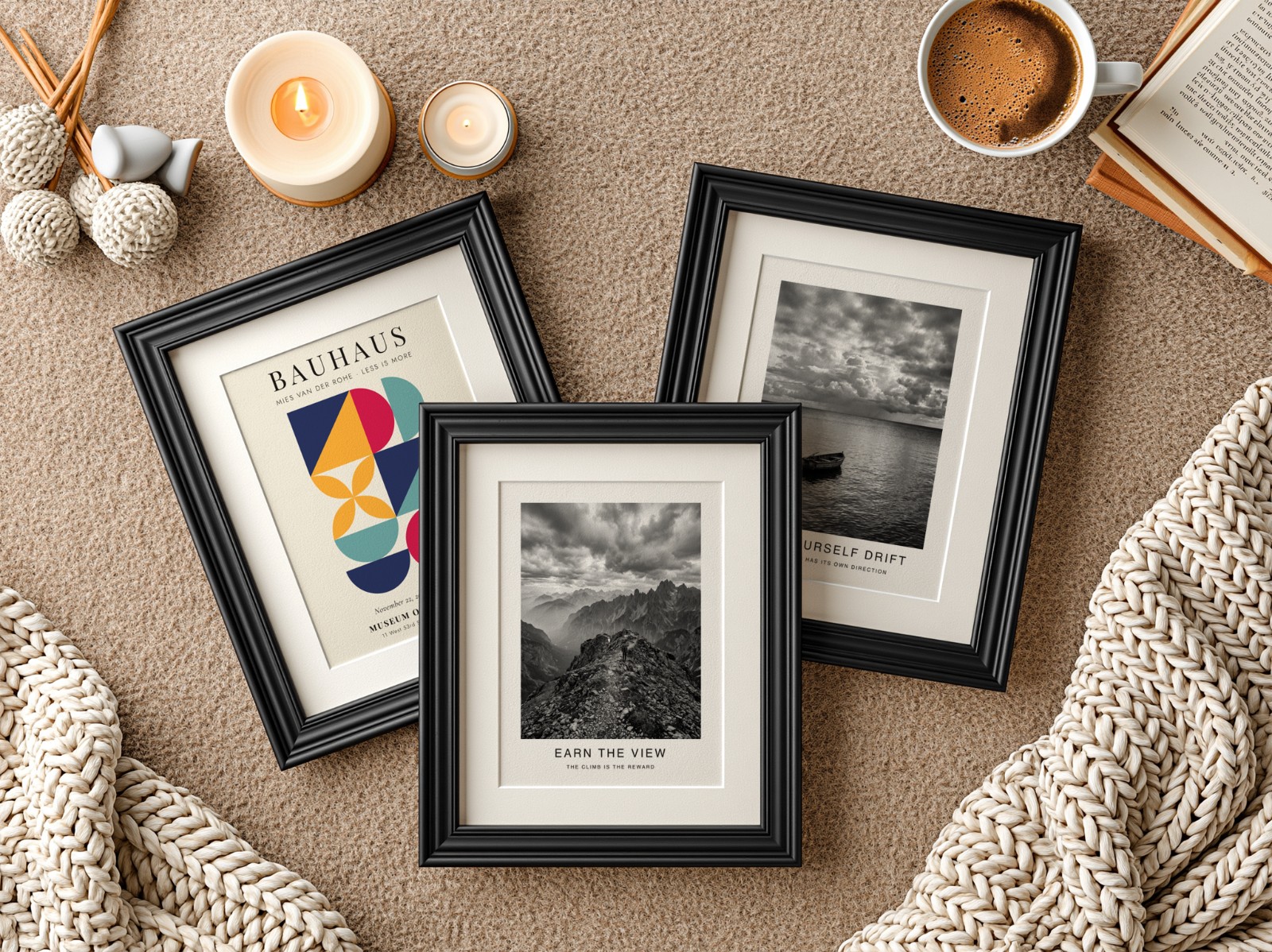 Three Black Frames with Mats on Knit Blanket showing a black and white mountain print, a black and white seascape print and 1 more design