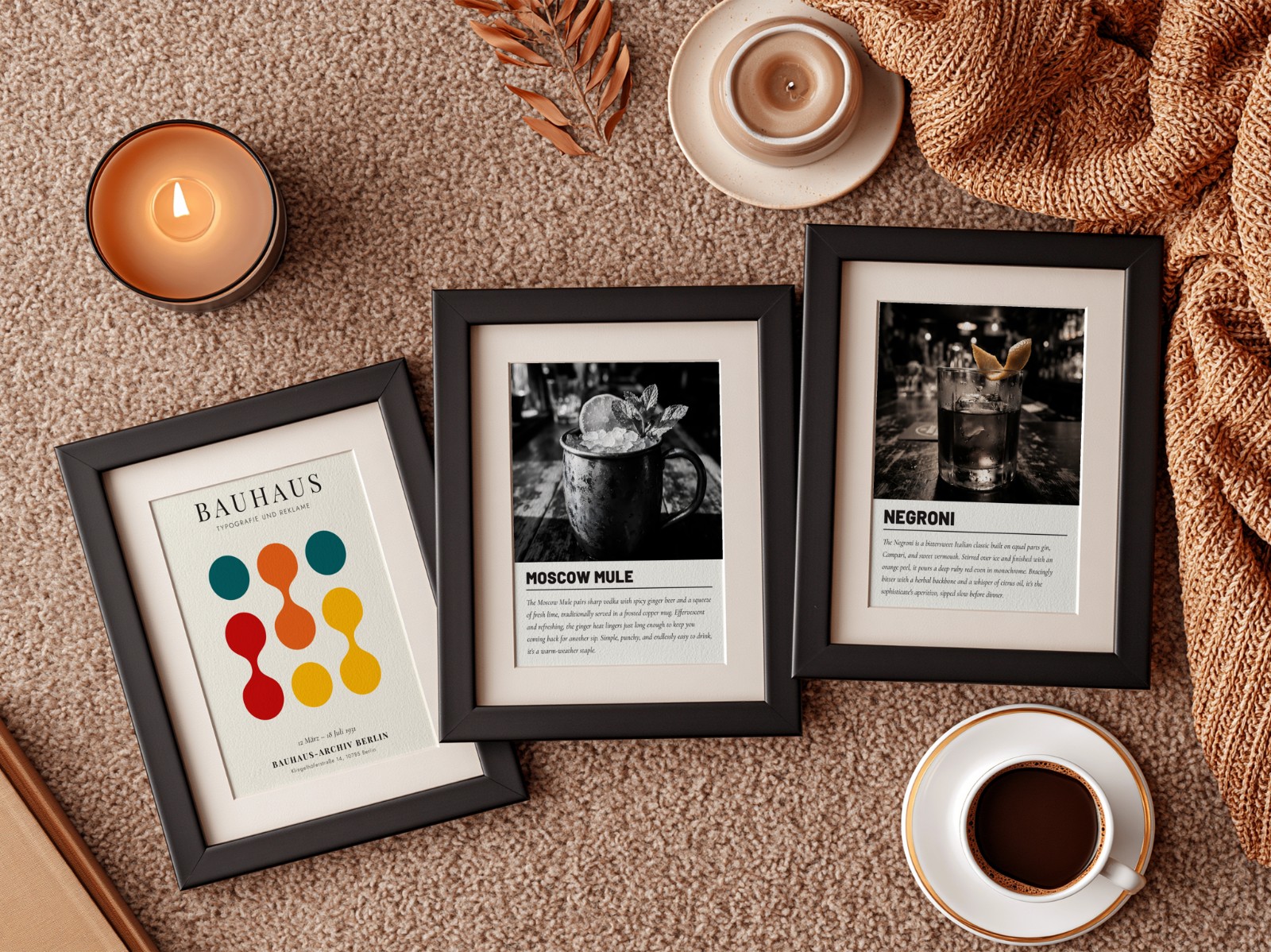 Three Black Frames with Mats on Rust Rug showing a Moscow Mule cocktail print, a Negroni cocktail print and 1 more design