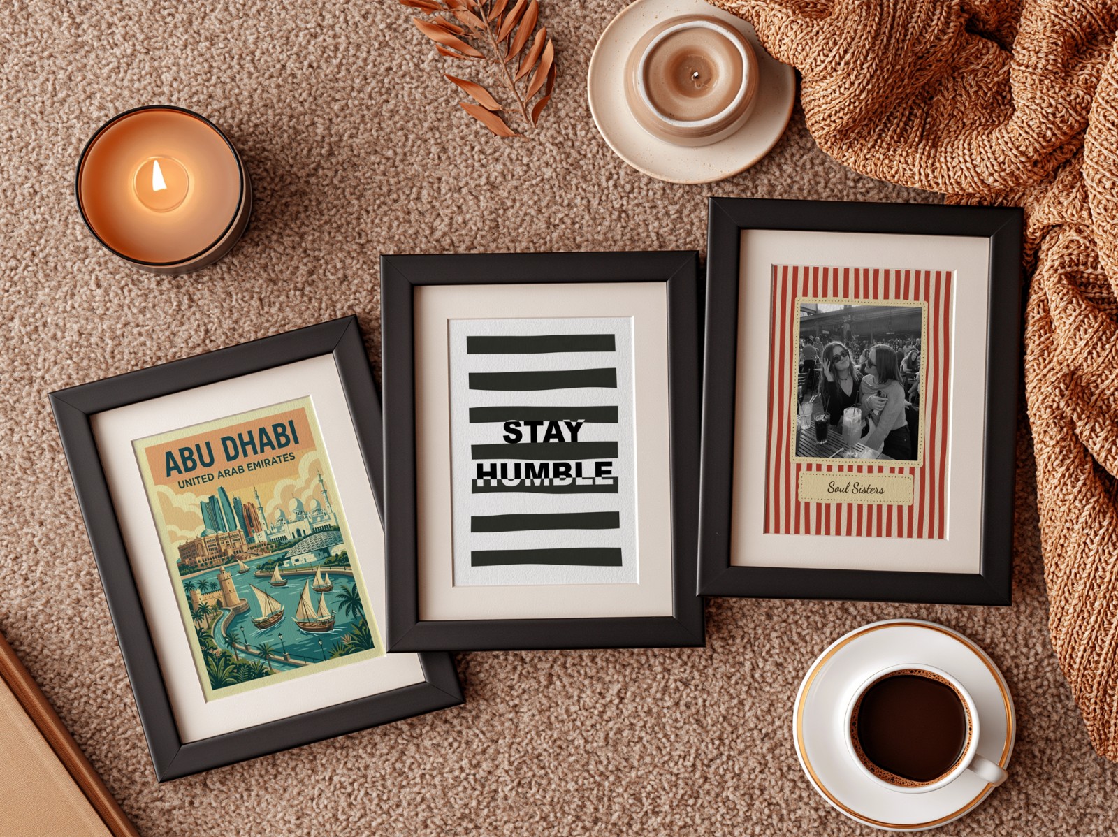 Three Black Frames with Mats on Rust Rug showing a Stay Humble typography print, a retro Soul Sisters print and 1 more design