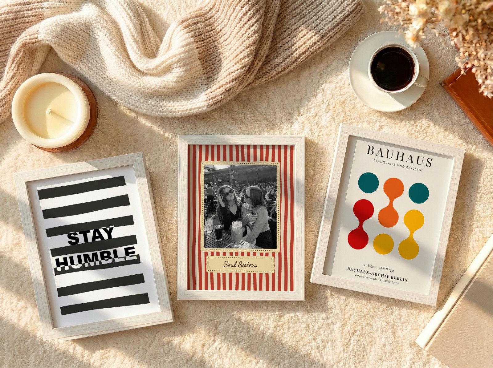Three White Frames Flat Lay on Cream Rug showing a Bauhaus circles print, a Stay Humble typography print and 1 more design