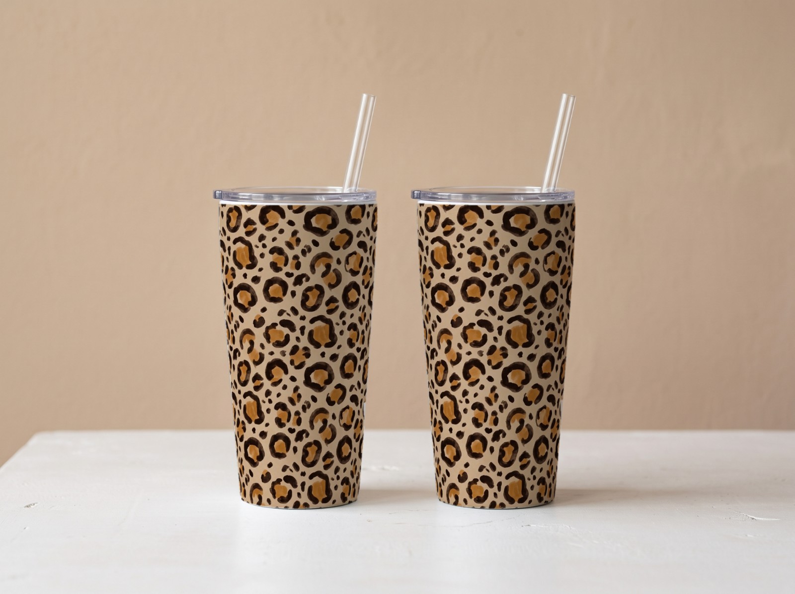 Two Tapered Tumblers Against a Beige Wall showing a neutral leopard print