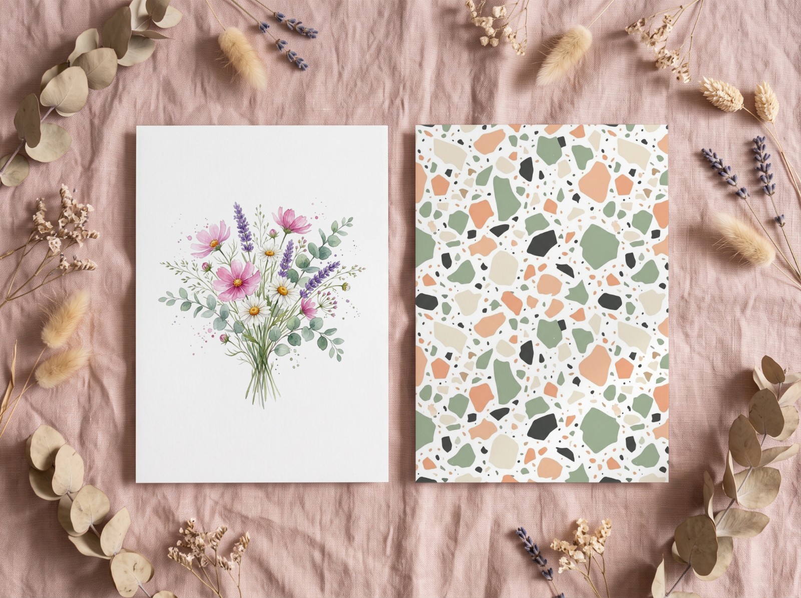 Two White Art Prints Flat Lay on Pink Linen with Dried Flowers showing a watercolour wildflower bouquet and a pastel terrazzo pattern