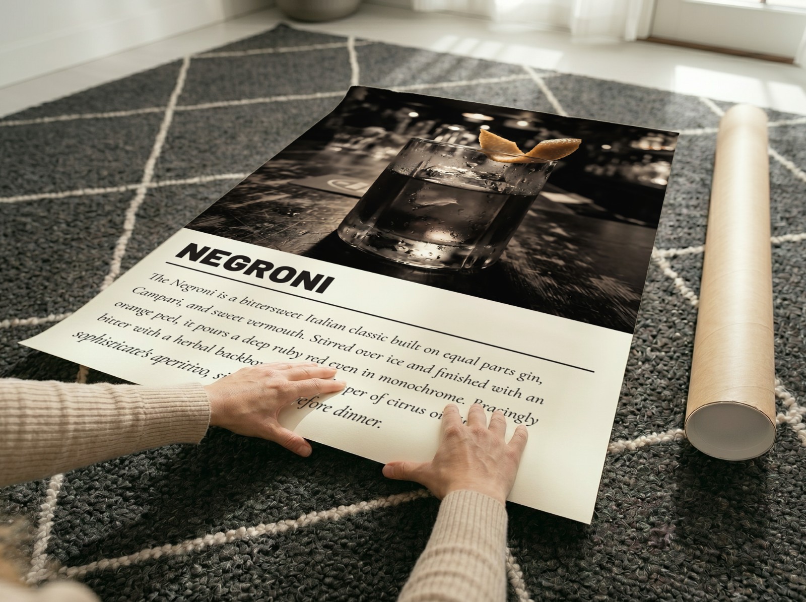 Unframed Poster Unrolling on Patterned Rug showing a Negroni cocktail print