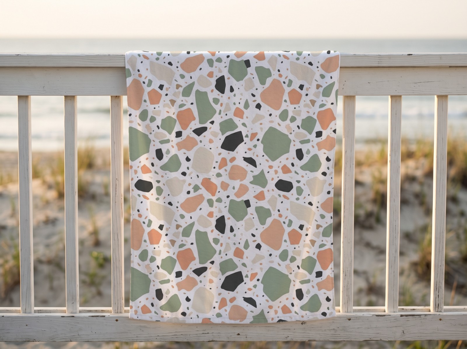 White Beach Towel on a Beach House Railing showing a pastel terrazzo pattern