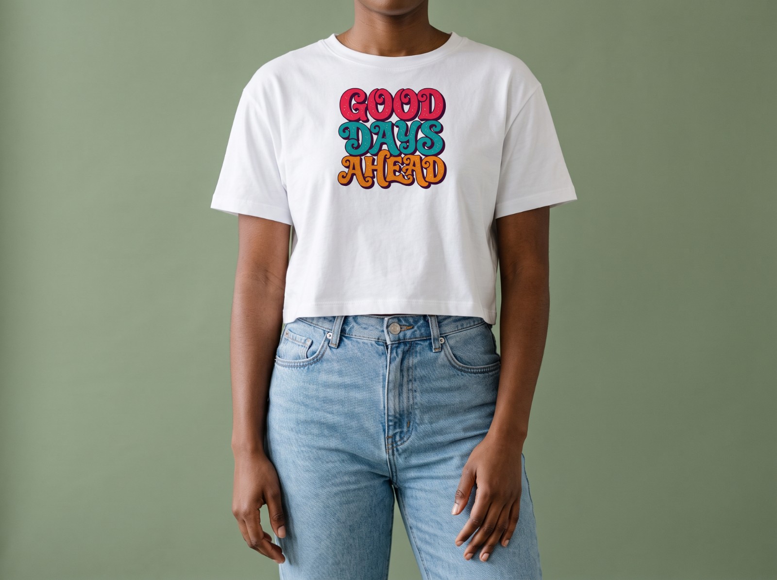 White Crop Top on a Woman against a Sage Green Backdrop showing a retro Good Days Ahead lettering