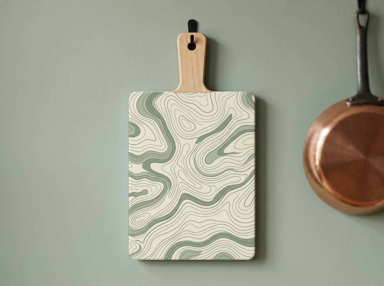 White Cutting Board with Handle on a Sage Green Wall showing a sage topographic map pattern