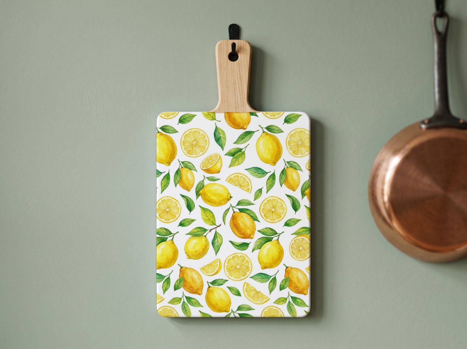 White Cutting Board with Handle on a Sage Green Wall showing a watercolour lemon pattern