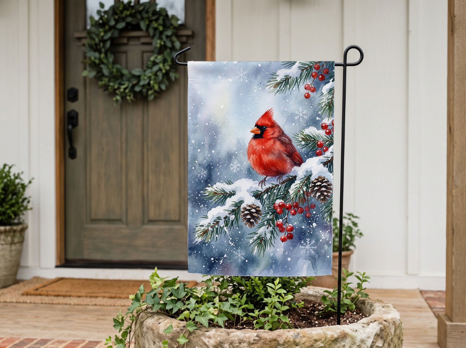 White Garden Flag by a Farmhouse Front Door showing a winter cardinal design
