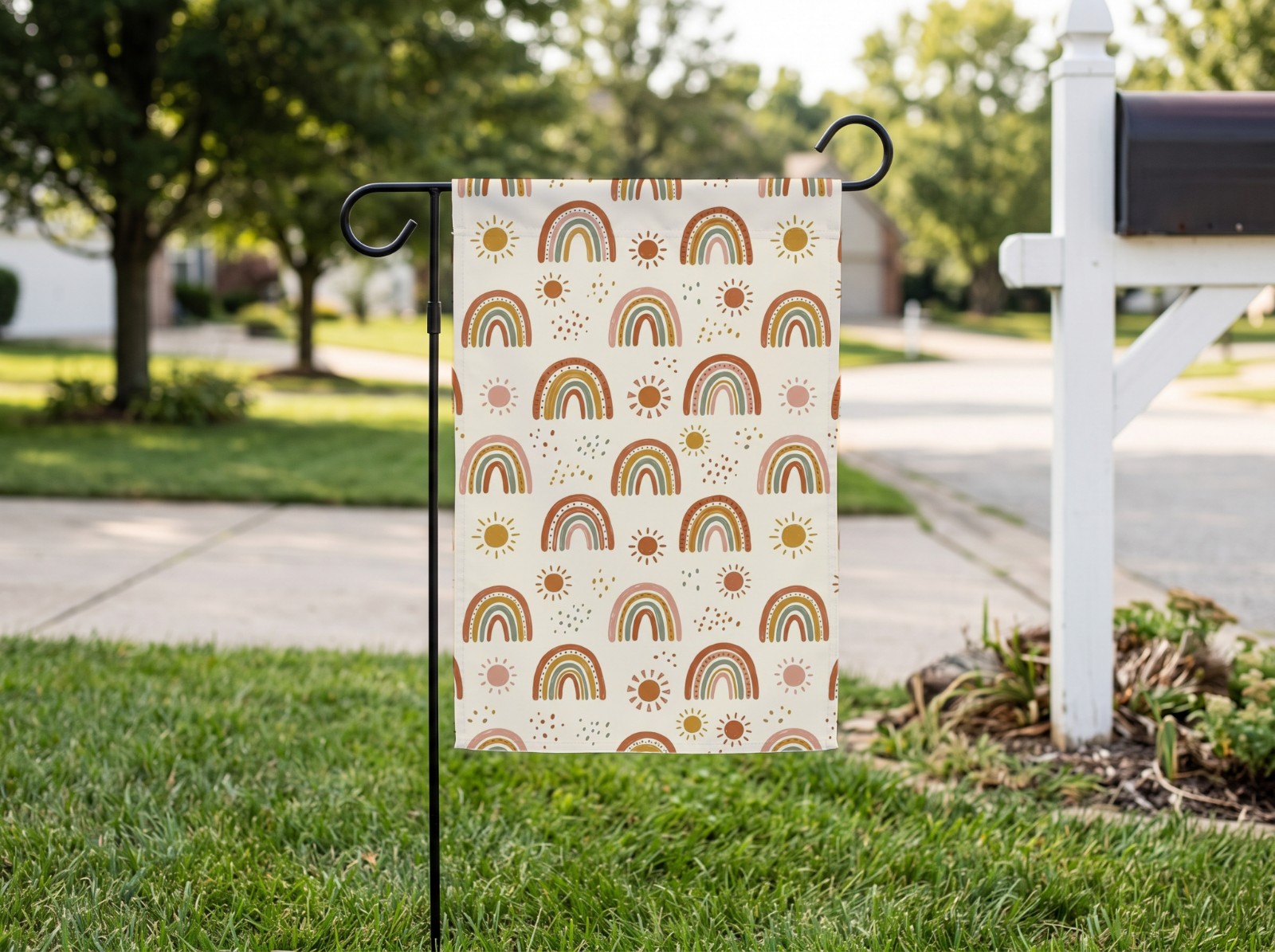 White Garden Flag on a Lawn by a Mailbox showing a boho rainbow pattern
