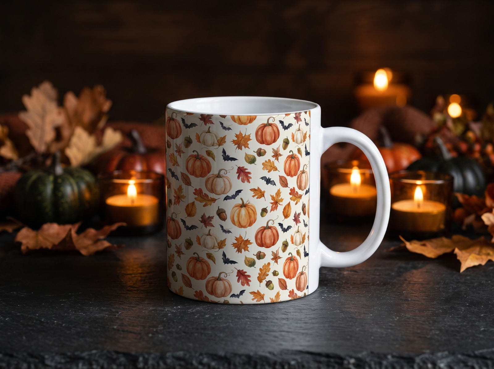 White Halloween Mug with Candles on Dark Slate showing a watercolour pumpkin and autumn leaf pattern