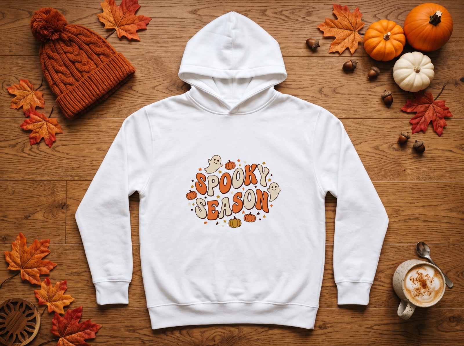 White Hoodie Halloween Flat Lay with Pumpkins and Autumn Leaves showing a groovy retro Spooky Season design