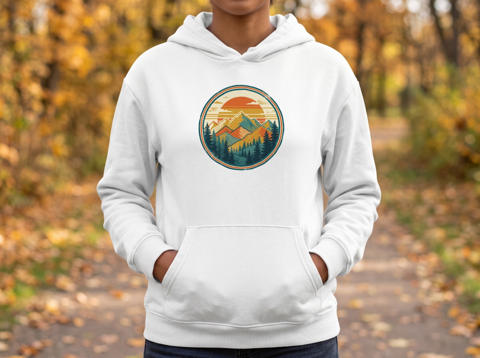 White Hoodie on a Woman in an Autumn Park showing a retro mountain sunset badge