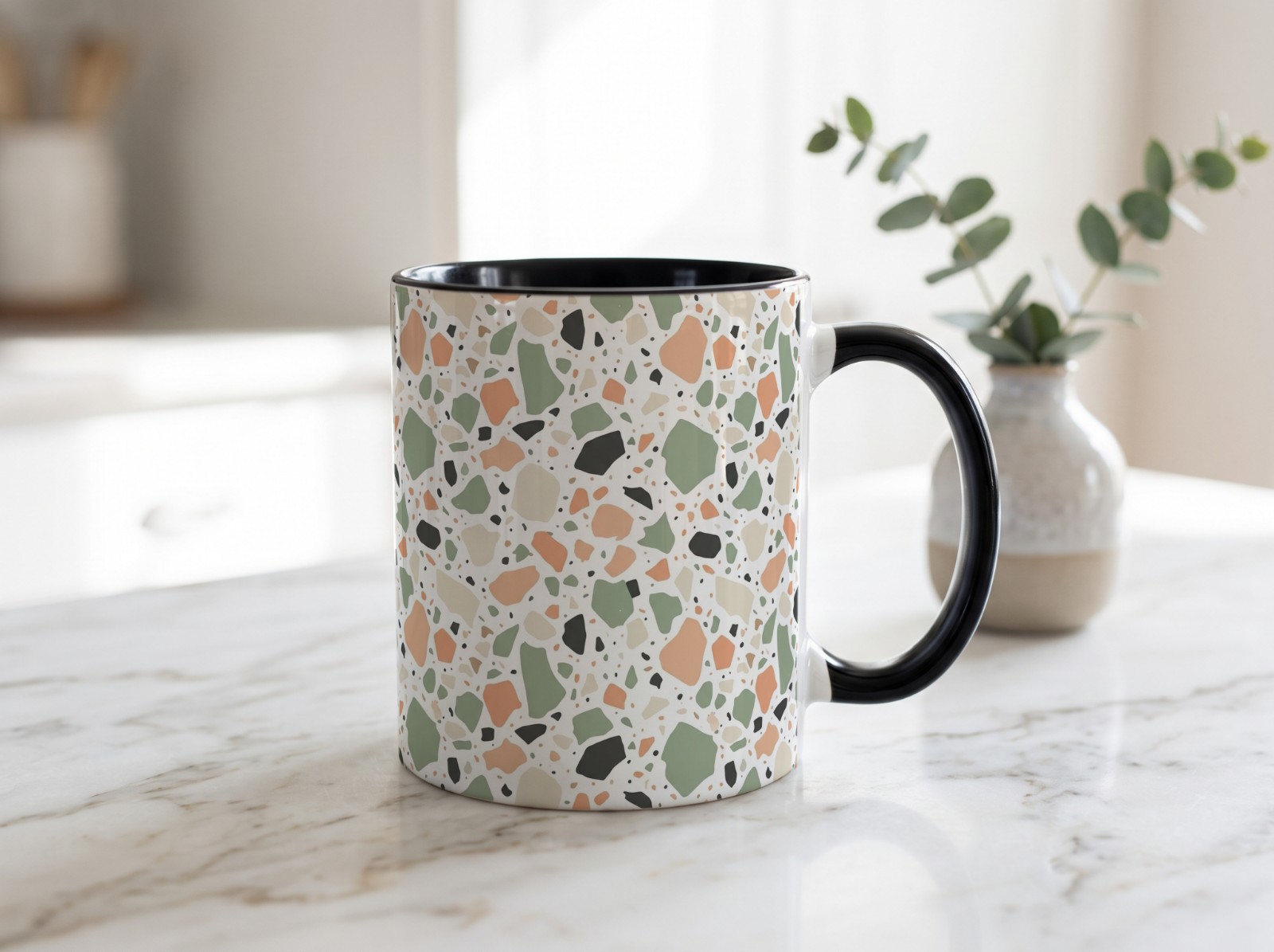 Black Accent Mug on a Marble Counter showing a pastel terrazzo pattern
