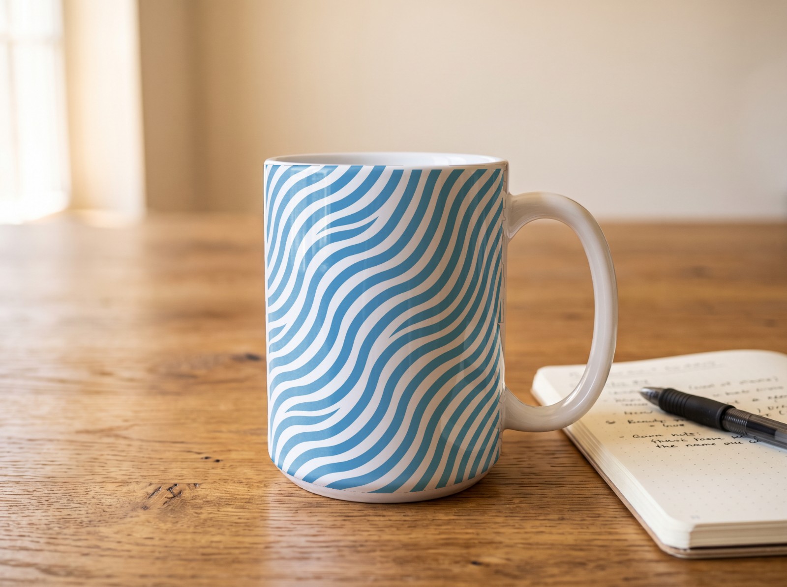 White Mug on a Wooden Desk with Notebook showing an Everything Flows wave print
