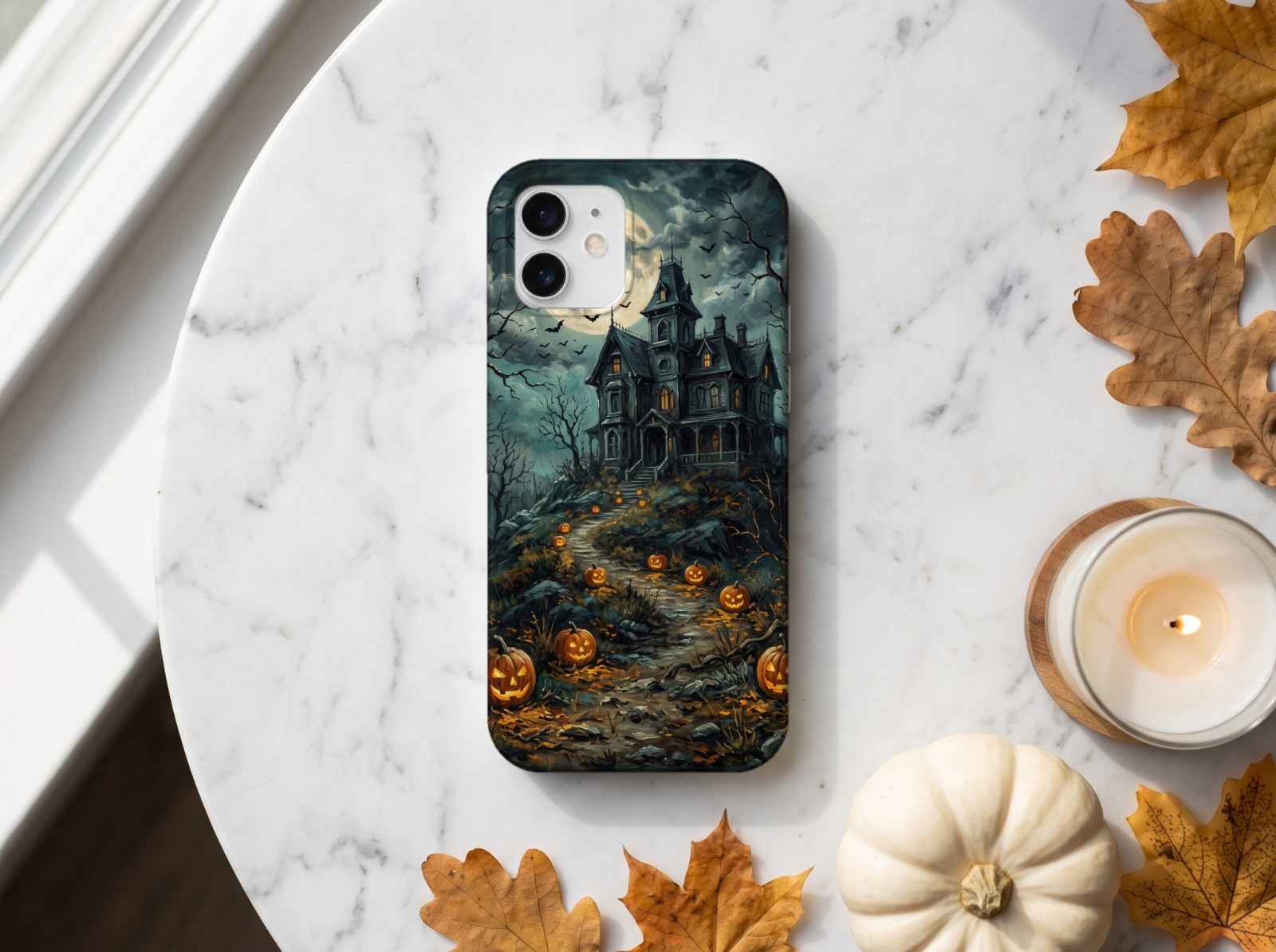 White Phone Case Halloween on Marble with a Pumpkin and Candle showing a vintage haunted house painting