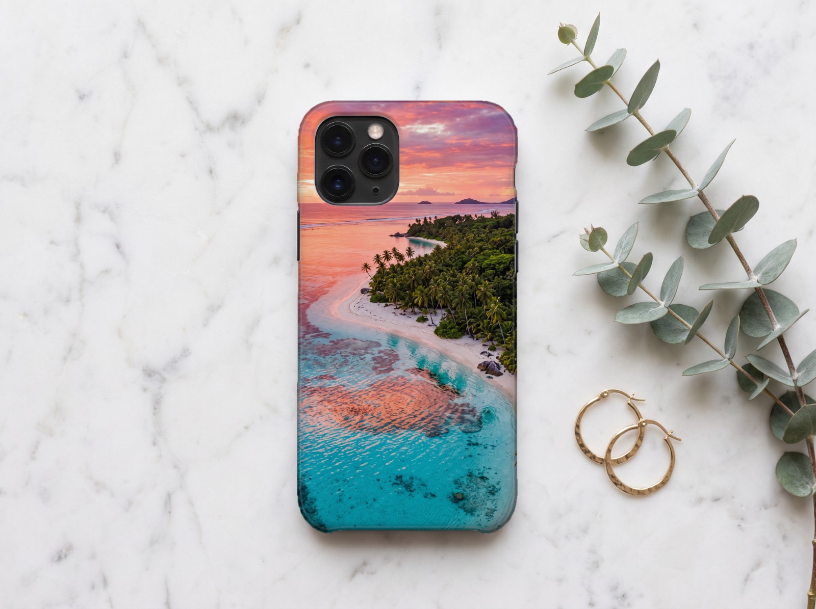 White Phone Case on Marble with Eucalyptus showing a tropical lagoon sunset photo