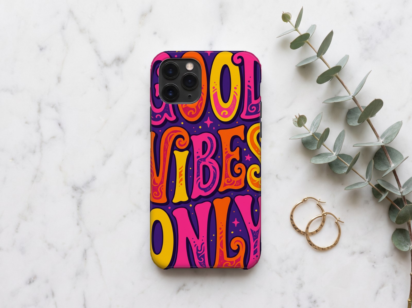 White Phone Case on Marble with Eucalyptus showing a retro Good Vibes Only typography print