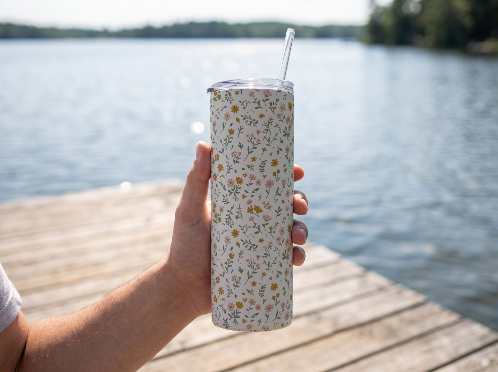 White Skinny Tumbler Mockup Held in a Hand on a Lake Dock example
