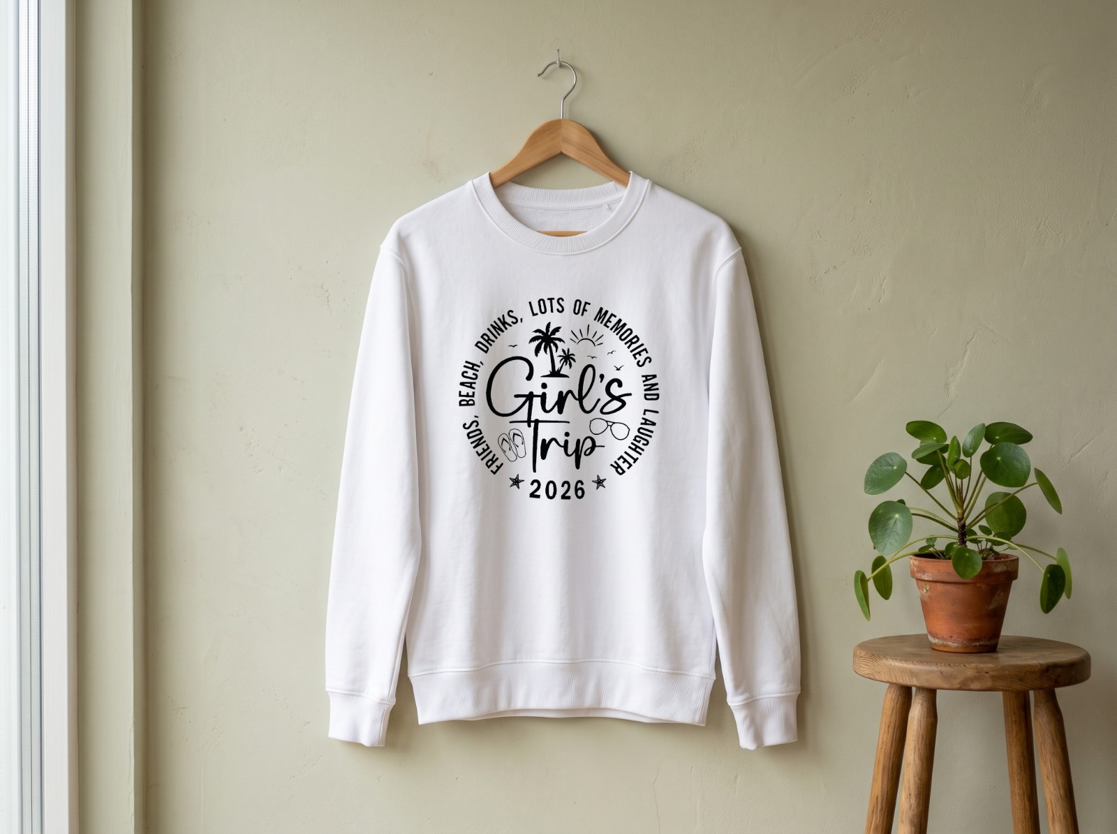 White Sweatshirt on a Wooden Hanger showing the Girl's Trip 2026 design