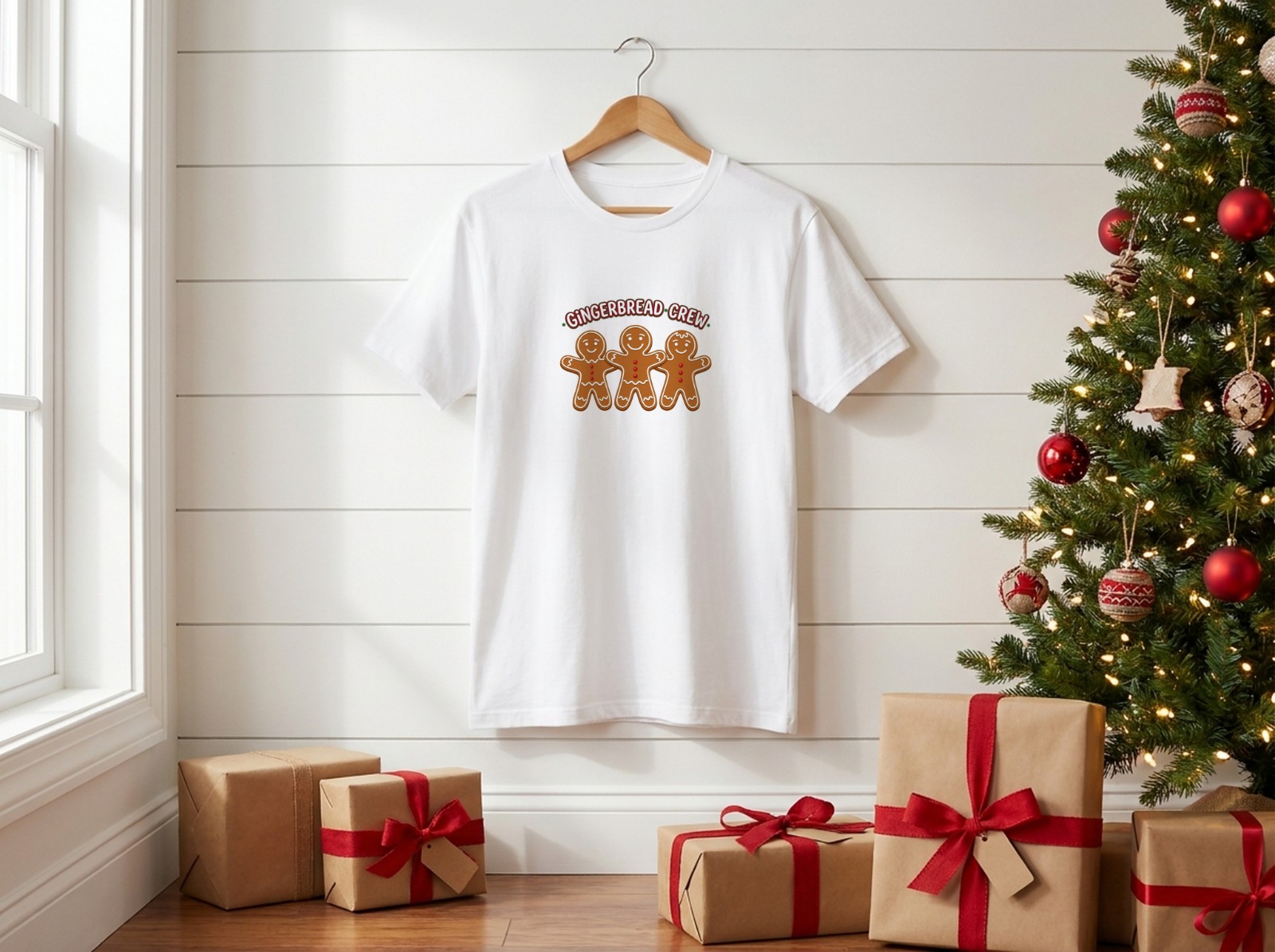 White T-Shirt Christmas on a Hanger by a Christmas Tree showing a Gingerbread Crew design