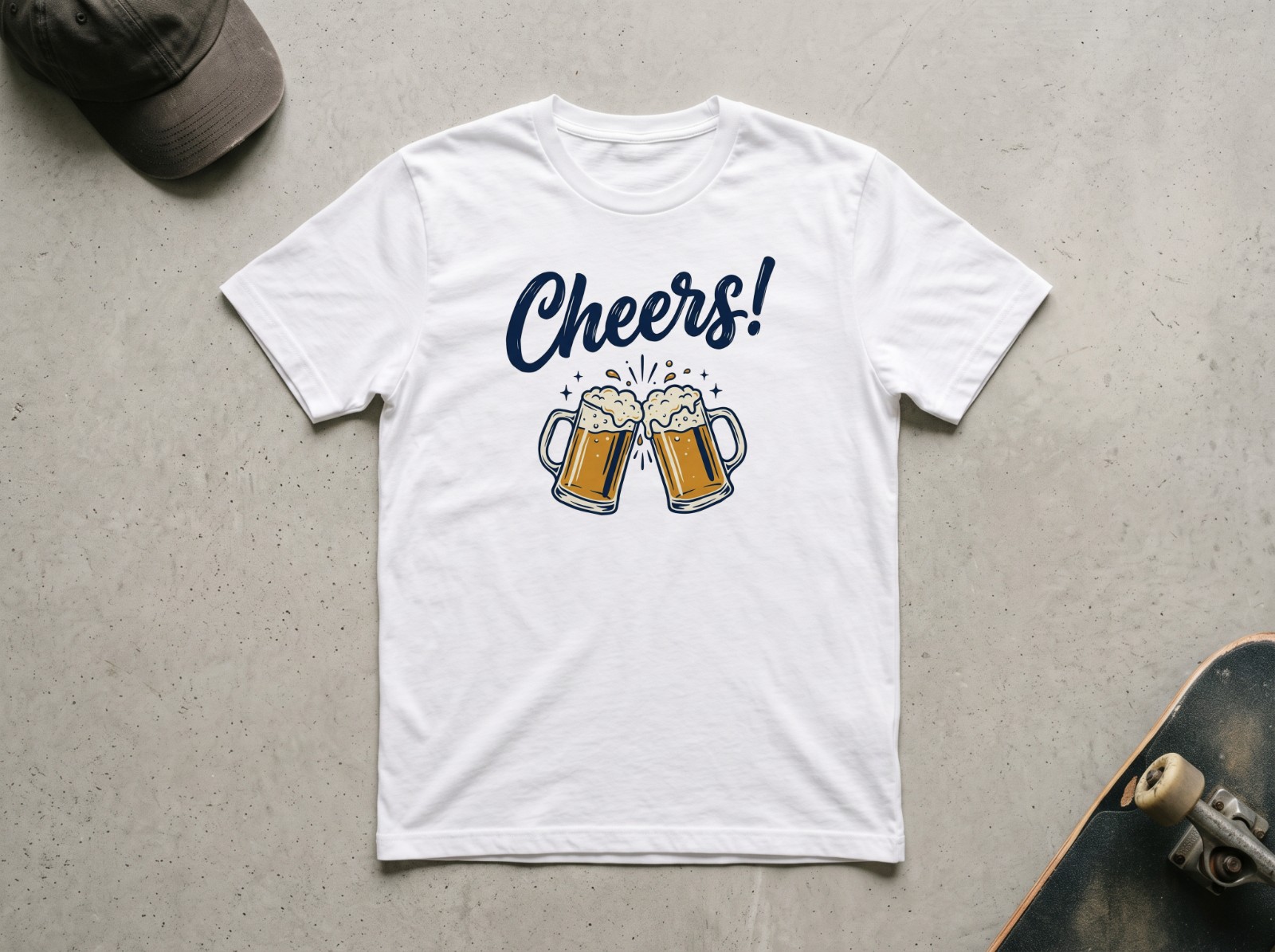 White T-Shirt Flat Lay on Concrete with a Skateboard showing a Cheers lettering design