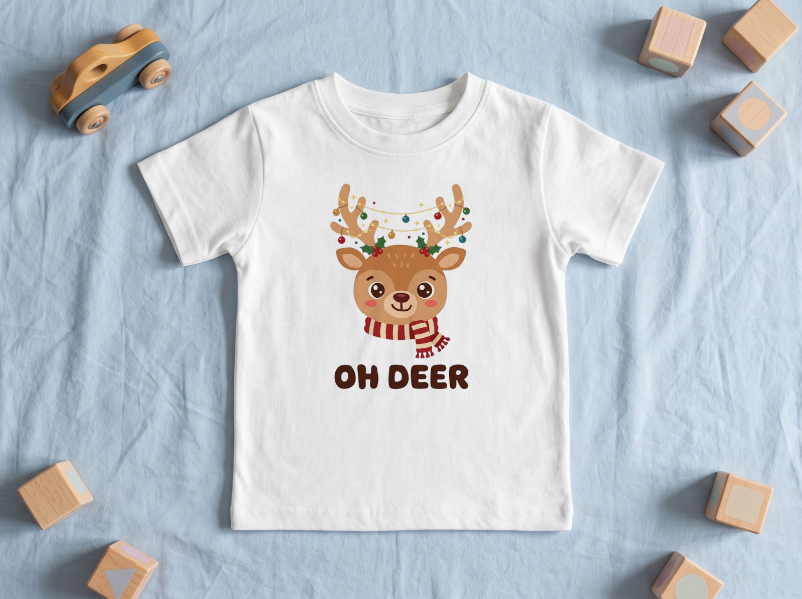 White Toddler T-Shirt Flat Lay with Wooden Toys showing an Oh Deer reindeer design