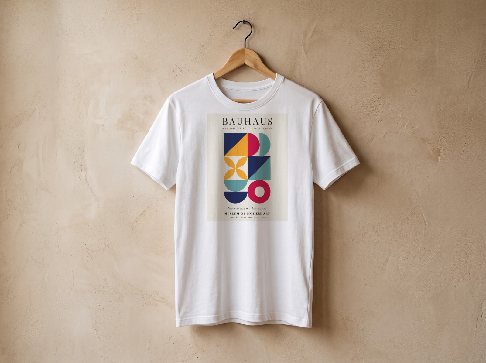 White T-Shirt on a Wooden Hanger showing a Bauhaus Less is More print